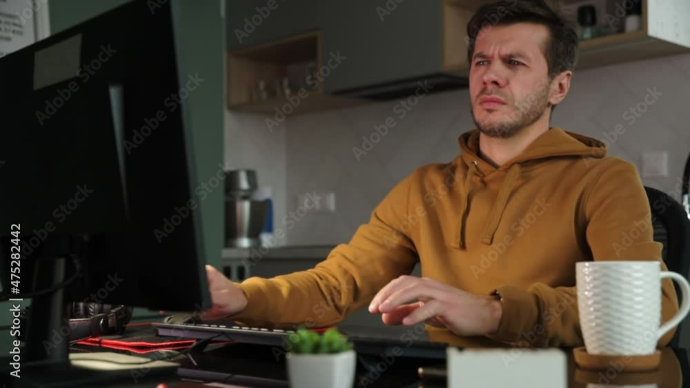Man sleeping at table at home office with computer. Freelancer remotely working late. Emotional stress and burnout Man sleeping at table at home office with computer. Freelancer remotely working late. Emotional stress and burnout