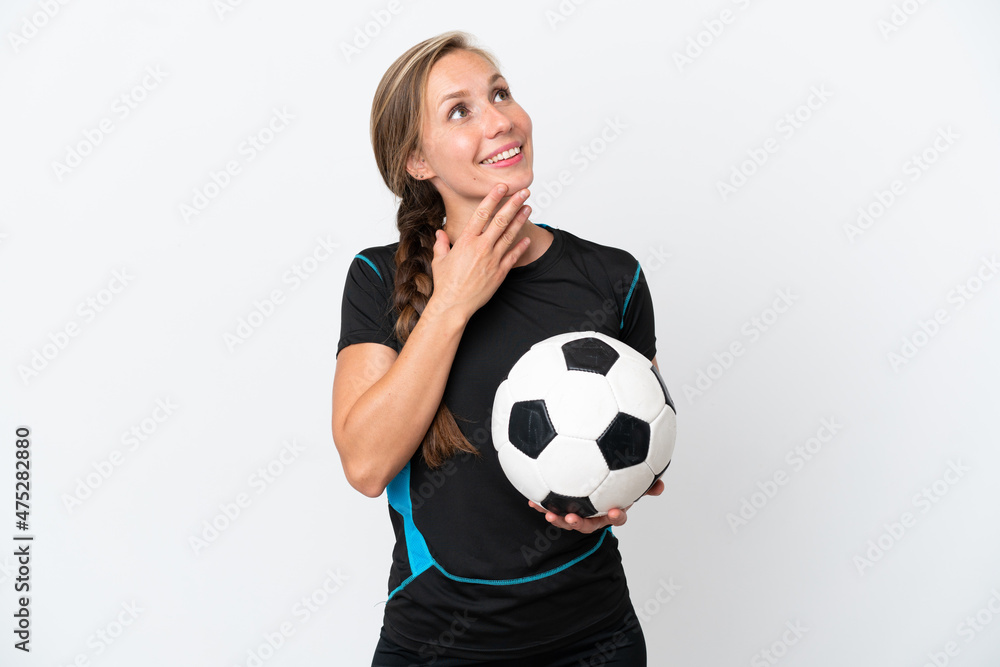 Young football player woman isolated on white background looking up while smiling Young football player woman isolated on white background looking up while smiling