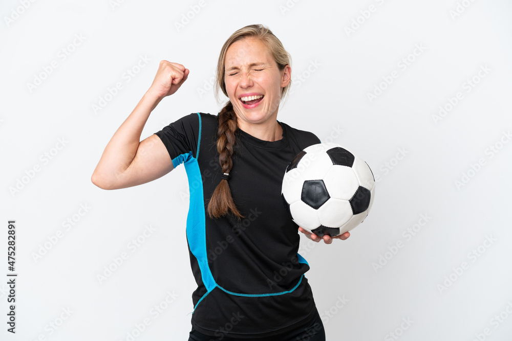 Young football player woman isolated on white background celebrating a victory