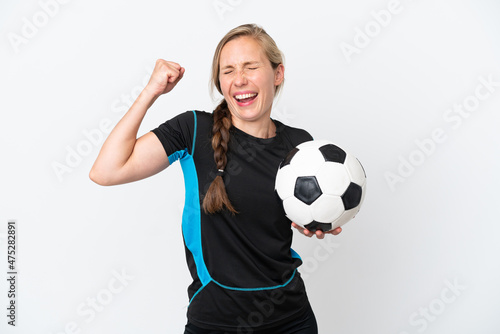 Young football player woman isolated on white background celebrating a victory © luismolinero
