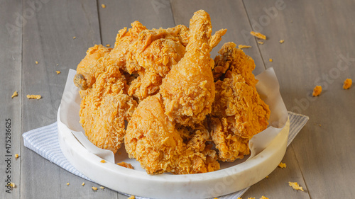 fried crispy chicken on white plate on wood
