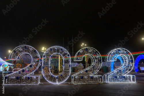 New Year 2022 inscription on the street . Garlands illumination in the Christmas Night