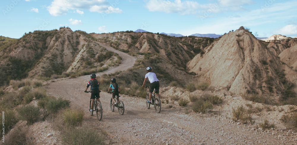 family biking in wilderness countryside landscape