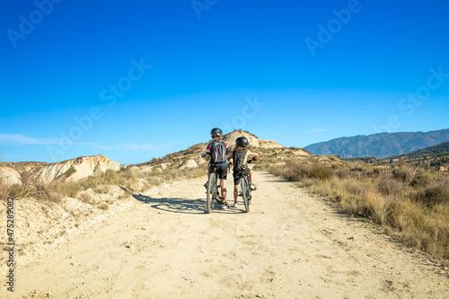 two boys biking in countryside