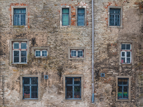 Several windows on facade of the urban historic building front view, Tallinn, Estonia

