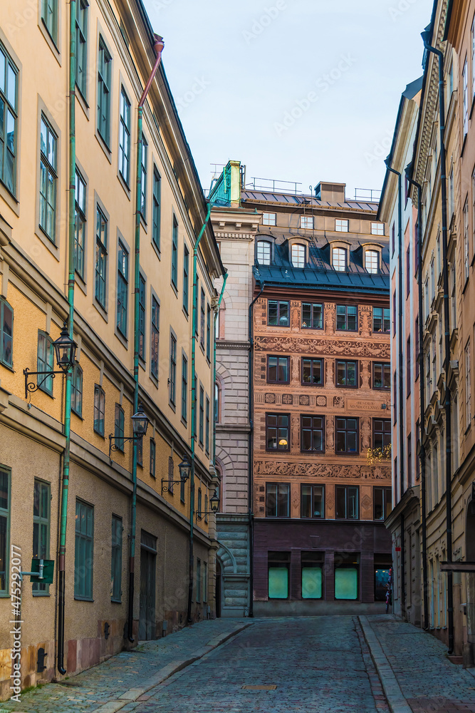 Perspective view of historical buildings on the Salviigrand Alley in winter day, Stockholm, Sweden

