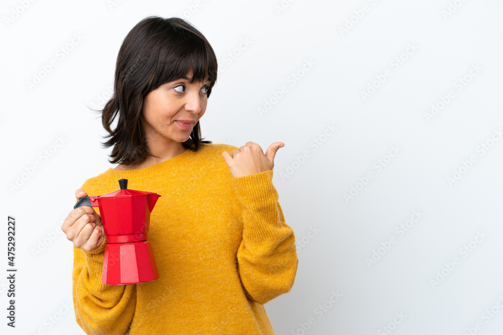 Young mixed race woman holding coffee pot isolated on white background pointing to the side to present a product Young mixed race woman holding coffee pot isolated on white background pointing to the side to present a product