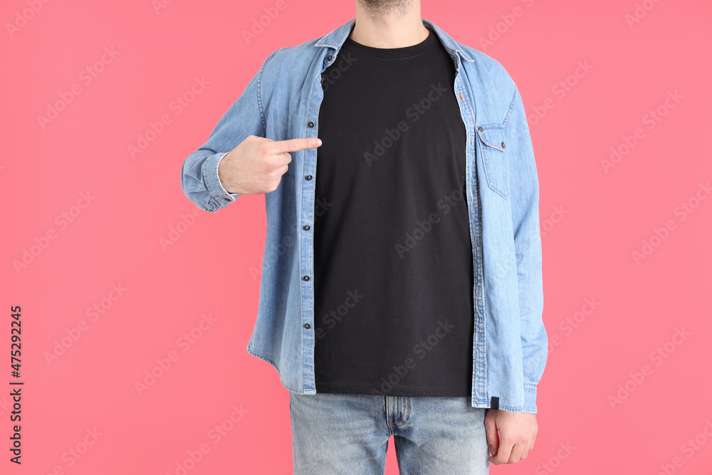 Man in blank black t-shirt on pink background Man in blank black t-shirt on pink background