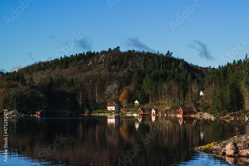 Scenic landscape of village on the fjord and mountains. Beautiful nature of Norway at sunny autumn day. Lusefjord.