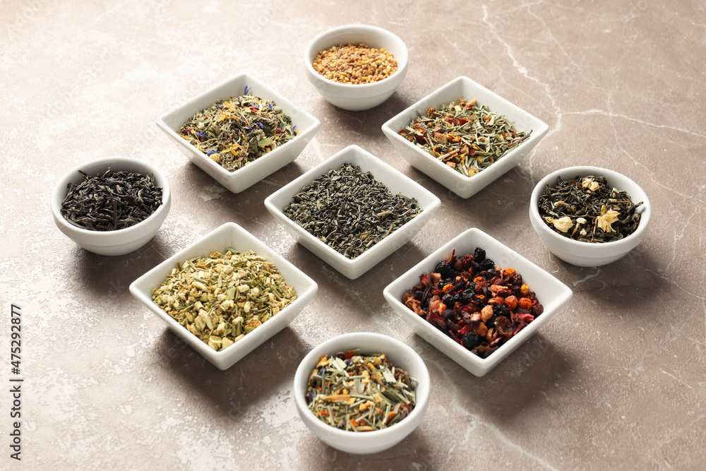 Flat lay with different types of tea on textured background
