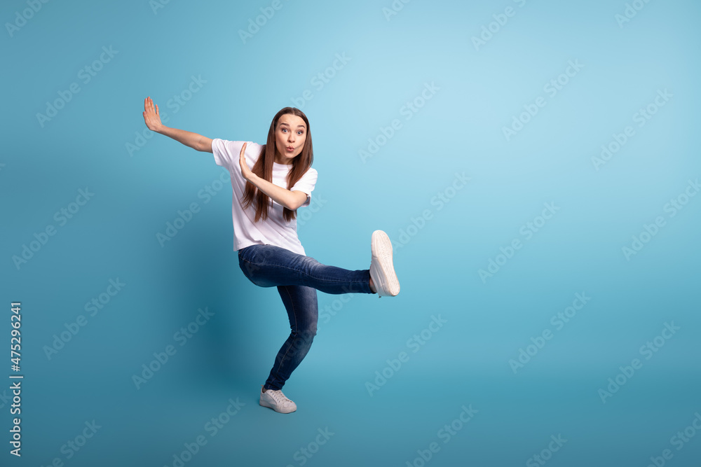 Full length photo of young cheerful woman have fun playful fool club dance isolated over blue color background Full length photo of young cheerful woman have fun playful fool club dance isolated over blue color background