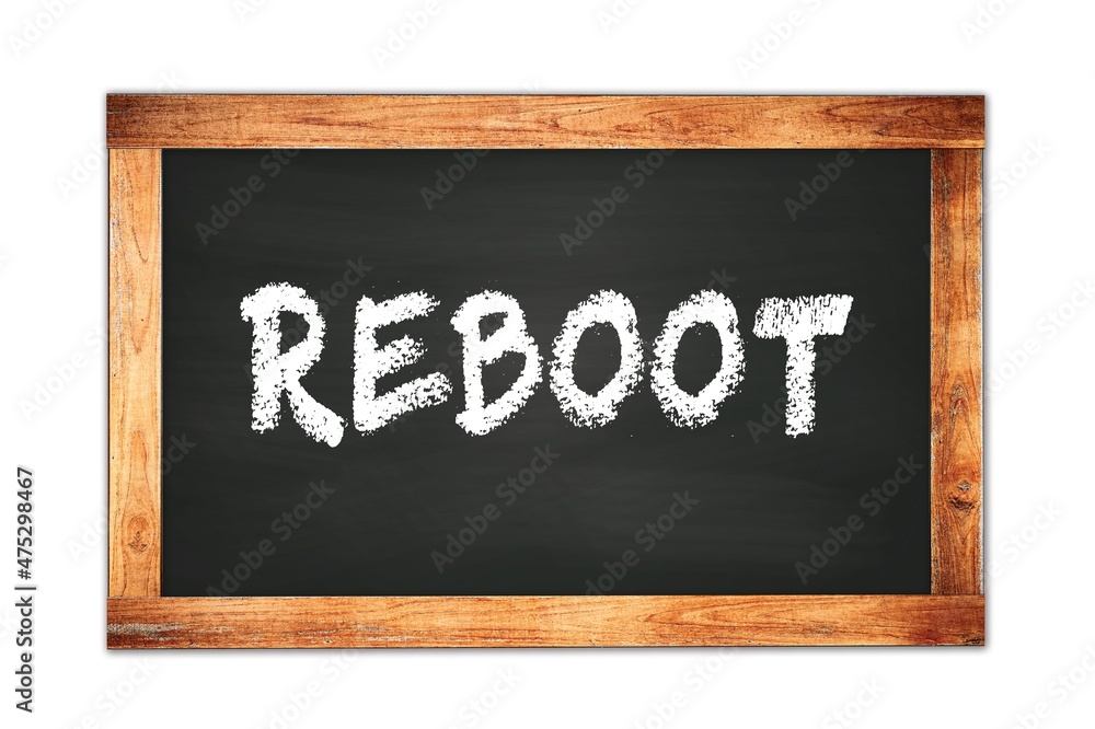 REBOOT text written on wooden frame school blackboard. REBOOT text written on wooden frame school blackboard.