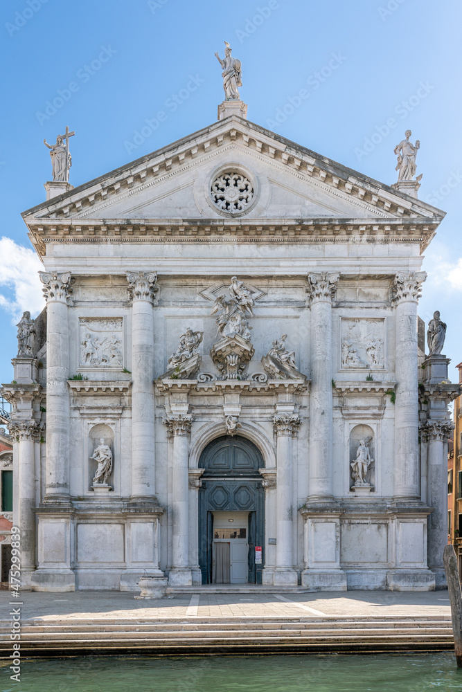 White marble church San Stae on Grand Canal in Venice with blue sky