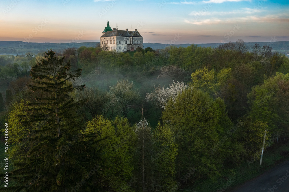 Aerial view of the Olesko castle. A very beautiful castle in foggy dark weather. Lviv region, Ukraine. Tourism, travel.