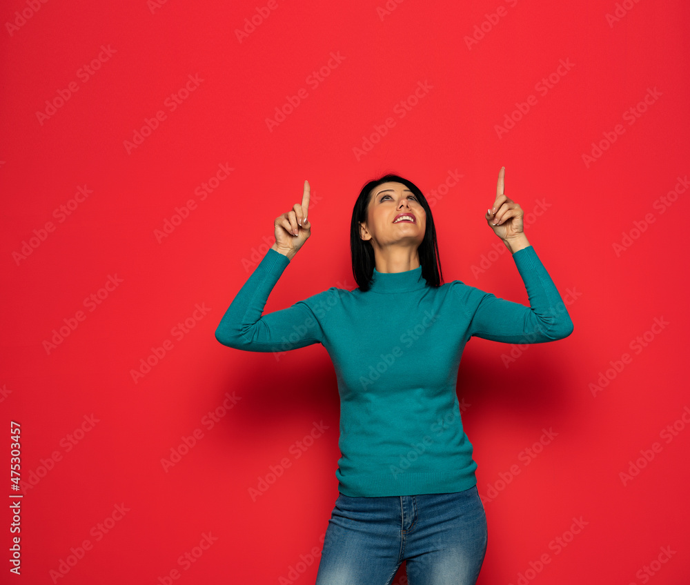 Young woman over isolated red background pointing with the index fingers Young woman over isolated red background pointing with the index fingers