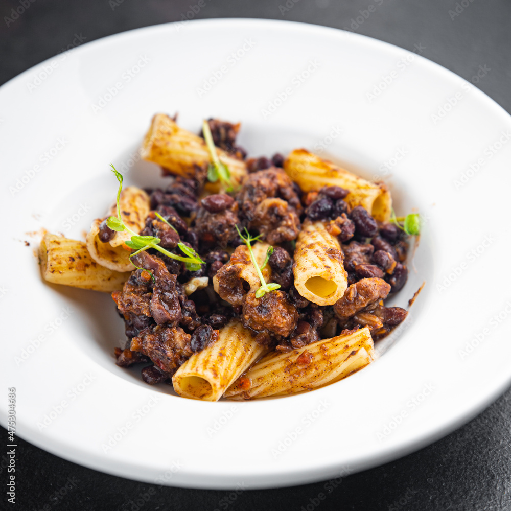 rigatoni pasta beans sauce healthy meal food diet snack on the table copy space food background rustic. top view veggie vegan or vegetarian food no meat rigatoni pasta beans sauce healthy meal food diet snack on the table copy space food background rustic. top view veggie vegan or vegetarian food no meat