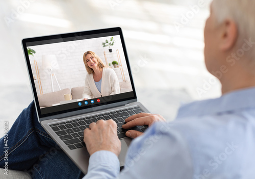 Elderly woman using laptop to communicate to her grownup daughter online, making video call with family member, indoors