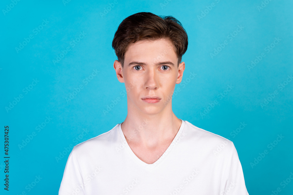 Photo of young handsome guy serious smart marketer wear casual clothes isolated over blue color background Photo of young handsome guy serious smart marketer wear casual clothes isolated over blue color background