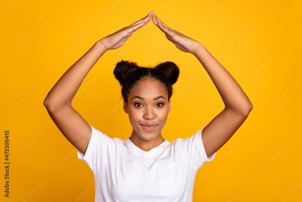 Photo of young afro lady hold arms buy new real estate relocation isolated over yellow color background Photo of young afro lady hold arms buy new real estate relocation isolated over yellow color background