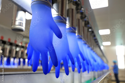 workers spot check the product quality of nitrile gloves on the production line, China photo