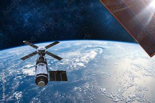 Fototapeta Naklejka Na Ścianę i Meble -  Cargo space craft Earth planet.Dark background. Sci-fi wallpaper.Space Station Orbiting Earth.Space ship.Space art wallpaper.Solar Observatory.Elements of this image furnished by NASA.3D illustration