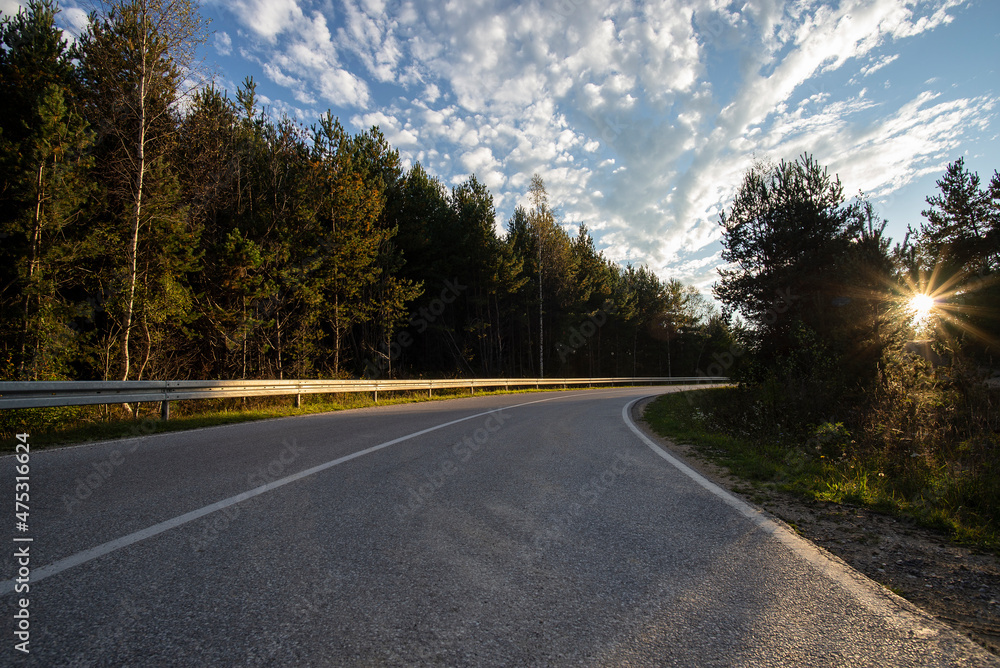 An empty mountain road and a beautiful sunset.