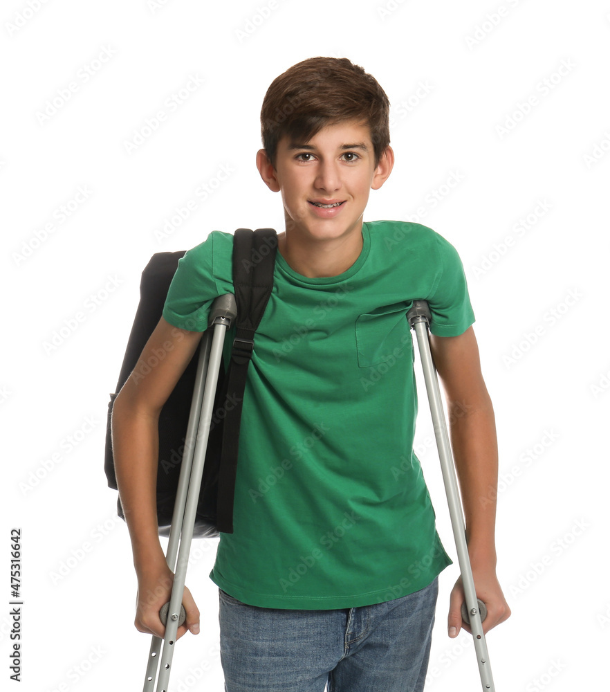 Teenage boy with injured leg using crutches on white background Teenage boy with injured leg using crutches on white background