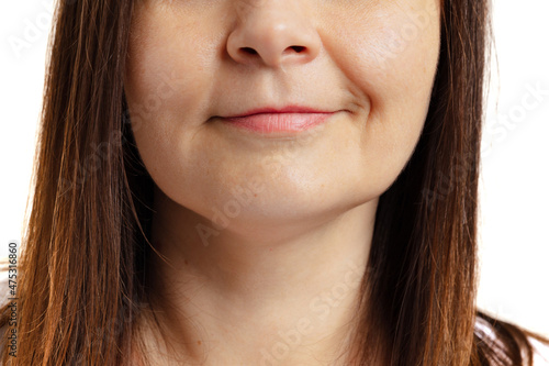 Close-up of female mouth with closed lips without makeup. Anti-aged cosmetology, medicine, dental health. Detailed.
