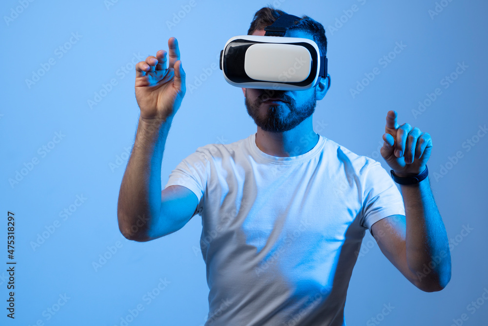 Model young man with beard in glasses of virtual reality. Augmented reality, science, future technology, VR. Futuristic 3d glasses with virtual projection. Model young man with beard in glasses of virtual reality. Augmented reality, science, future technology, VR. Futuristic 3d glasses with virtual projection.
