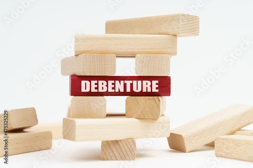 On the white surface there is a ruined tower made of planks, on a red plaque there is an inscription - Debenture