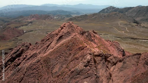 aerial shot of a drone flying over a red rock mountain photo