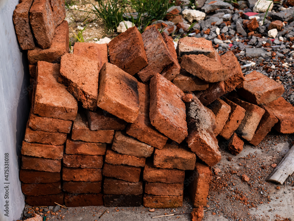 pile of red bricks left over from building materials
pile of red bricks left over from building materials
