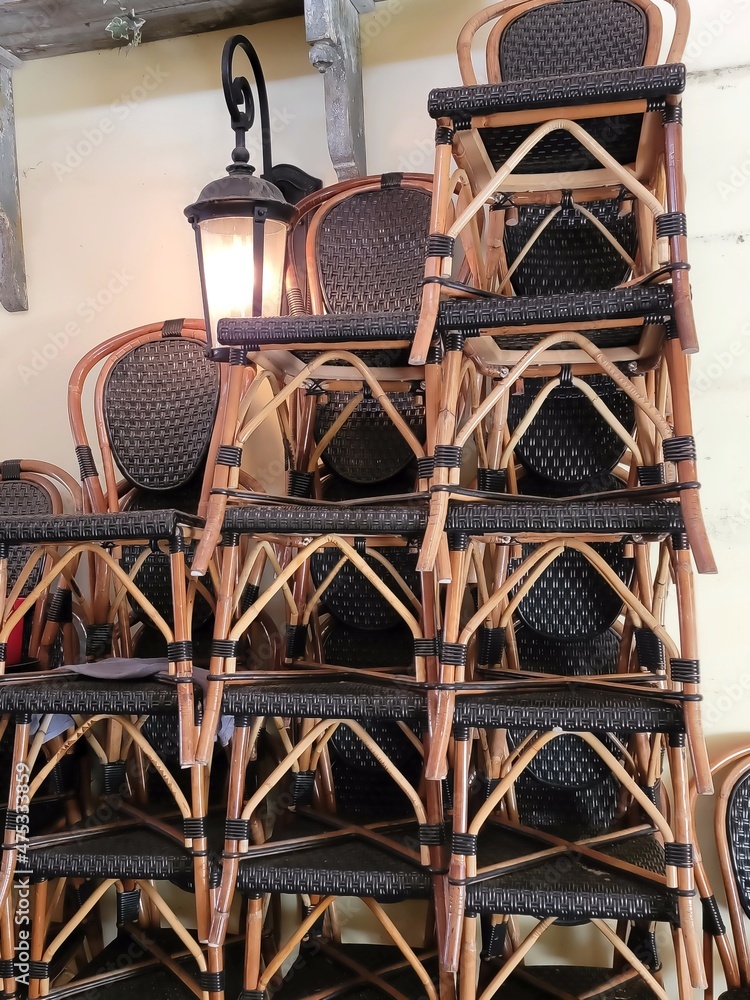Stacked bistro chairs and French country light Stacked bistro chairs and French country light