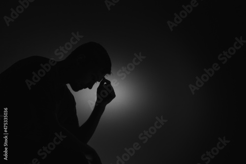 Silhouette of a man on a red background.
Silhouette of a guy in the dark.