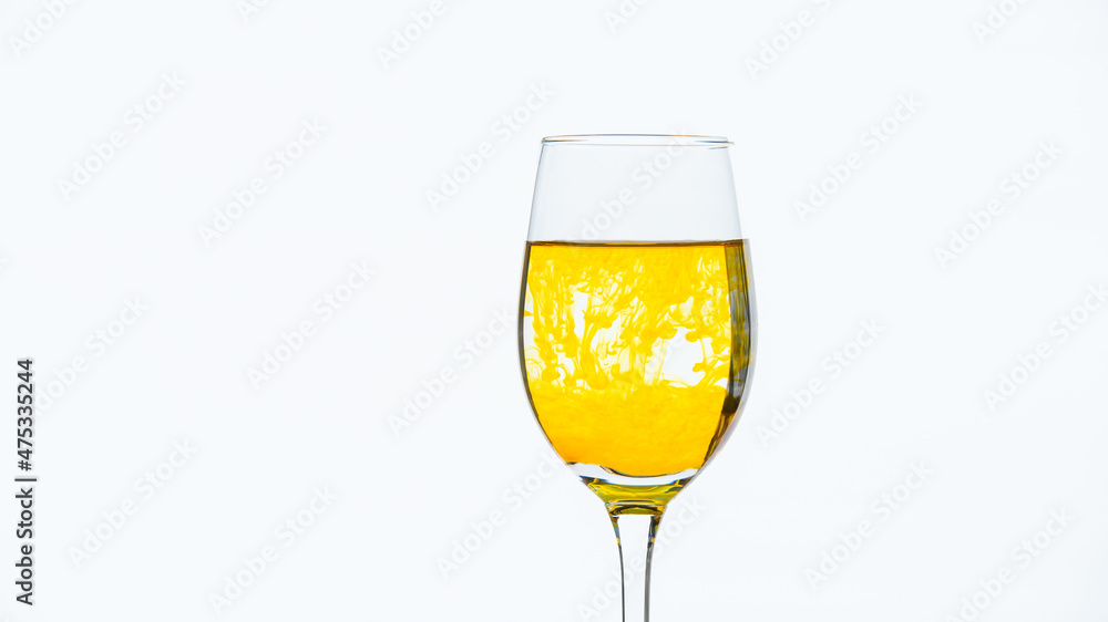 Yellow ink drips into the glass with water and creates beautiful colored lines.
Yellow ink drips into the glass with water and creates beautiful colored lines.
