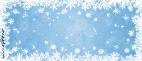 Shiny white frame with snowflakes on a light blue bokeh background. Festive Christmas banner