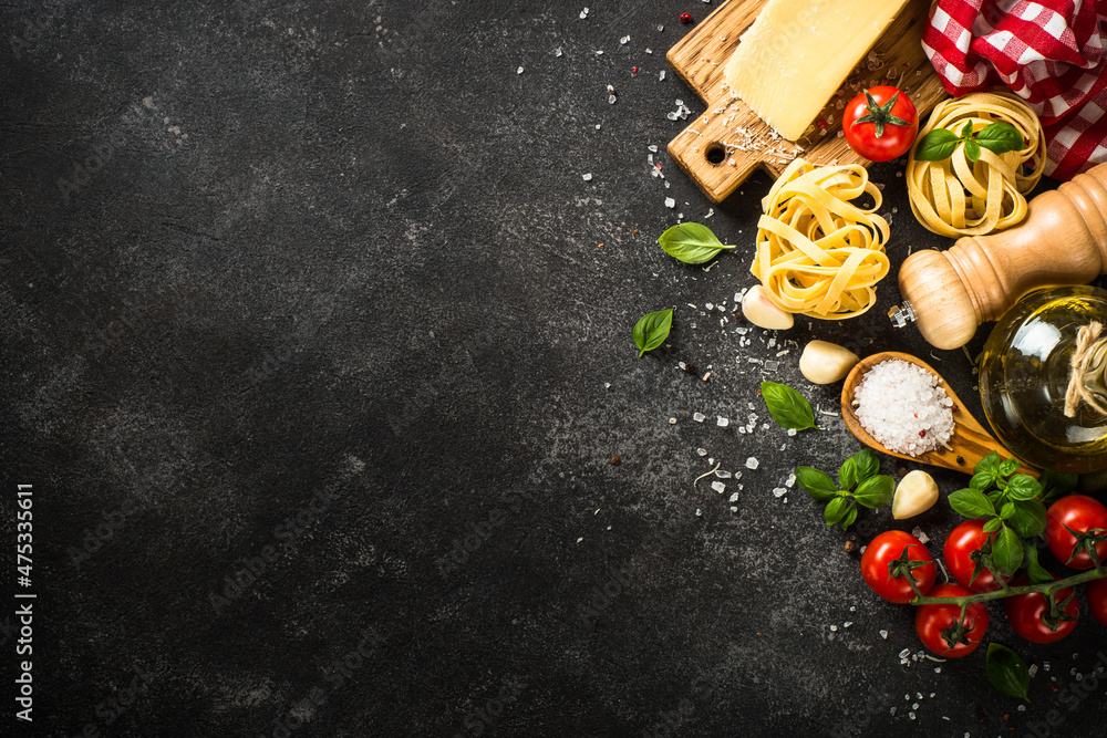 Pasta ingredients on black background. Italian food background. Pasta,  parmesan, fresh tomatoes and basil with spices. Top view with copy space.  Stock Photo | Adobe Stock