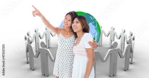 Composite image of two asian woman pointing in a direction against humans around a globe icon