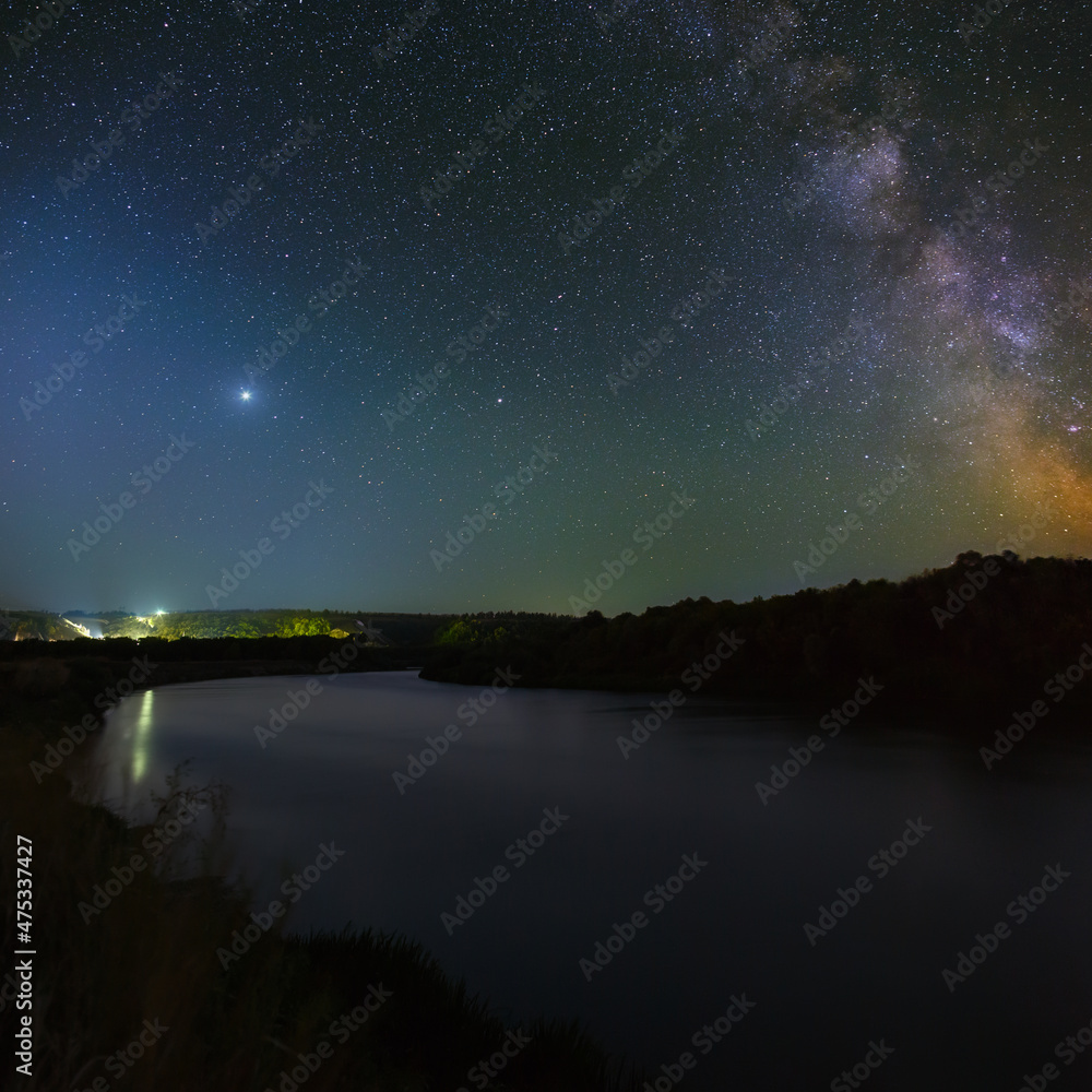Planet Jupiter in the night starry sky over the river. Planet Jupiter in the night starry sky over the river.