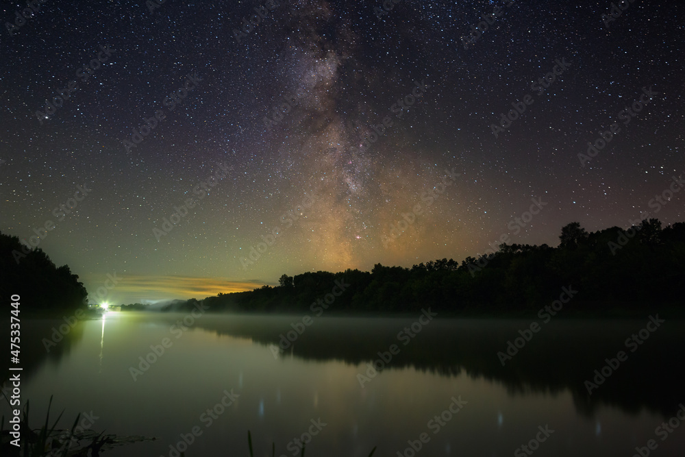Bright stars of the Milky Way in the night sky over the river with fog. Wonderful place for landscape. Bright stars of the Milky Way in the night sky over the river with fog. Wonderful place for landscape.
