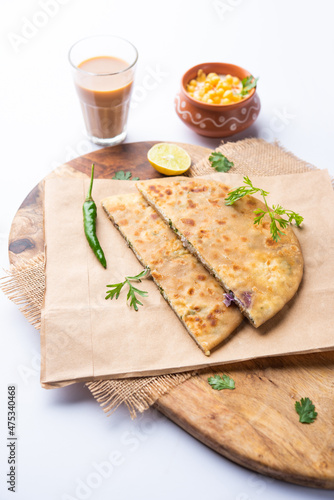 Paneer paratha is a popular North Indian flatbread made with whole wheat flour dough and stuffed with savory, spiced, grated paneer