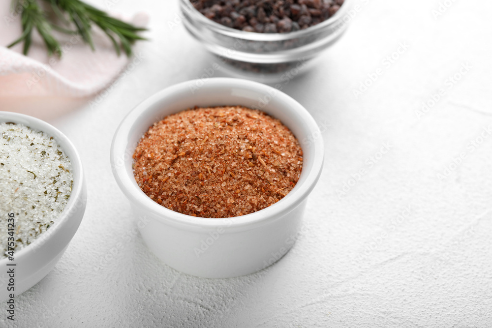 Different kinds of salt on white table, space for text Different kinds of salt on white table, space for text