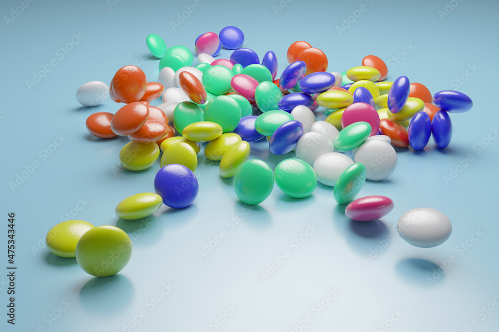 A handful of colored dragees scattered on a blue surface.