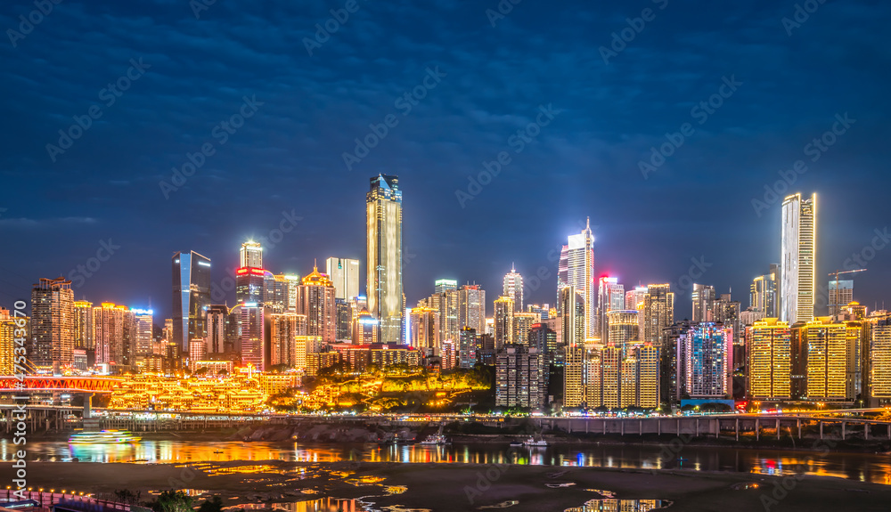 cityscape and skyline of downtown near water of chongqing at night