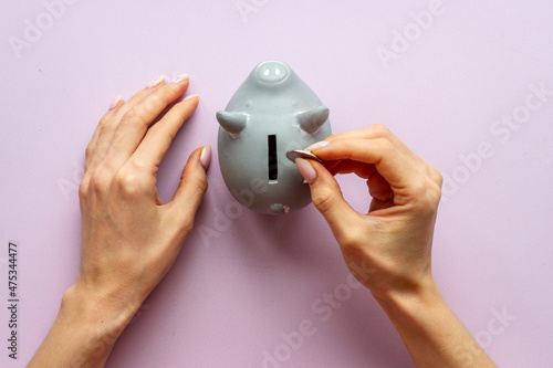 Piggy bank in hands top view. Family budget concept