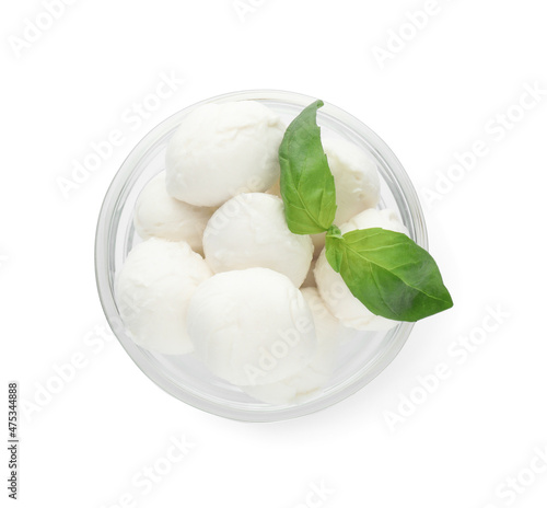 Bowl with mozzarella cheese balls and basil on white background, top view
