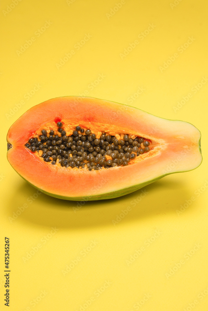 Papaya fruit on a yellow background. Tropical fruit. Papaya fruit on a yellow background. Tropical fruit.
