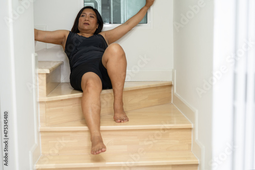 Asian middle-aged lady woman patient fall down the stairs because slippery surfaces