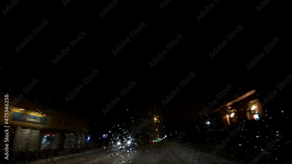 driving downtown suburban town on a snowy January evening driving downtown suburban town on a snowy January evening