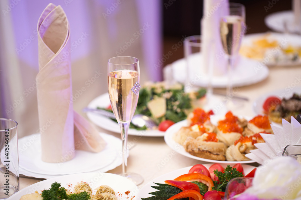 Served wedding banquet table with dishes in the restaurant Served wedding banquet table with dishes in the restaurant